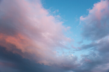 Wall Mural - closeup to evening sunset background with pink clouds and blue sky