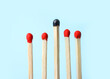 © New Africa - Row of whole matches and burnt one on light blue background. Uniqueness concept
