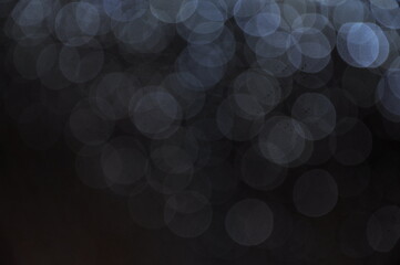 bokeh of water fly and lights on black background. wine grapes on black background.
