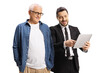 © Ljupco Smokovski - Professional man showing a tablet to a mature man