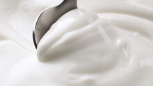 Sour cream close up, greek yogurt with spoon