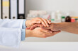 © cunaplus - Closeup shot of an unrecognizable doctor holding a patient's hand in comfort