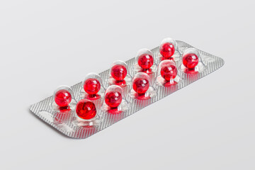 Wall Mural - Foil blister pack with red capsules on a light background