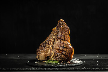 Wall Mural - Grilled BBQ T-Bone Steak or porterhouse steak with Fresh Rosemary. American cuisine. Restaurant menu, dieting, cookbook recipe. The concept of pral cooking meat