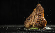 Grilled Premium Dry Aged T-bone Steak or porterhouse steak adding salt in a freeze motion on black background. USDA Prime Beef. Restaurant menu, cookbook recipe. Long banner format