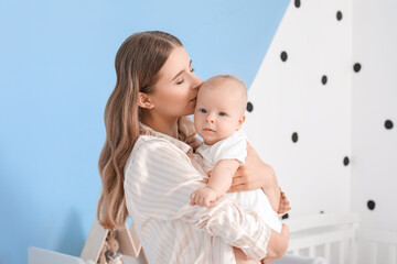 Wall Mural - Happy mother with cute little baby at home