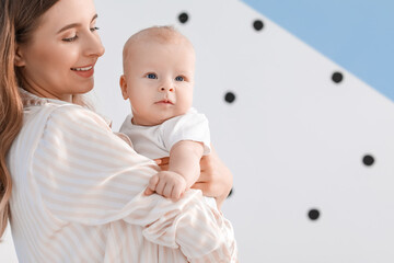 Wall Mural - Happy mother with cute little baby at home