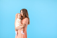 Happy Mother With Cute Little Baby On Color Background
