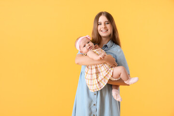 Wall Mural - Happy mother with cute little baby on color background