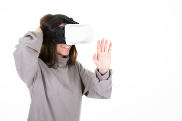 Smiling woman wearing virtual reality goggles headset box new generation progress concept trying to touch objects in vr in Studio shot on white background