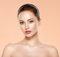 Wall Mural - portrait of beautiful young brunette woman with clean face. closeup face of young adult woman with c