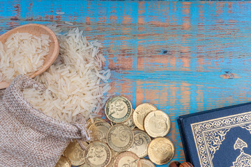 Poster - Holy Quran, Coins, Rosary and Rice. Zakat concept. Zakat is a form of alm-giving as a religious obligation