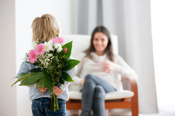 Poster - Beautiful blond boy, giving mother flowers and box with little gift for mothers day