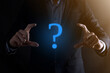 © Ivan - Businessman man hand hold interface question marks sign web. Ask quiestion online, FAQ concept, what where when how and why, search information on internet