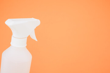 Sticker - Closeup shot of a spray bottle isolated on orange background