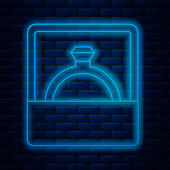 Glowing neon line Diamond engagement ring icon isolated on brick wall background. Vector.