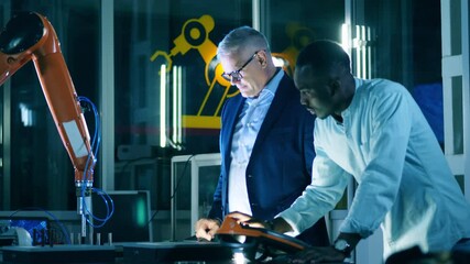 Wall Mural - two scientists are discussing a robot while operating it