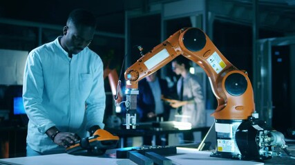 Wall Mural - african scientist is operating a robotic arm