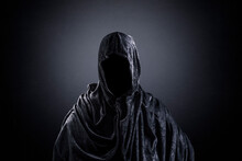 Scary Figure With Hooded Cape In The Dark