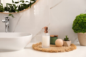 Canvas Print - Soap dispenser, plants and candle near vessel sink in bathroom