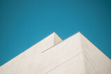 Fototapeta  - corner of modern white building against blue sky