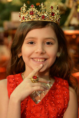 Wall Mural - Сute little girl in crown posing in studio