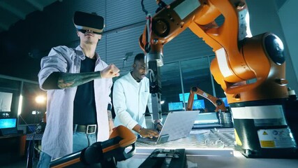 Wall Mural - male scientists are using vr-glasses to operate a robotic arm