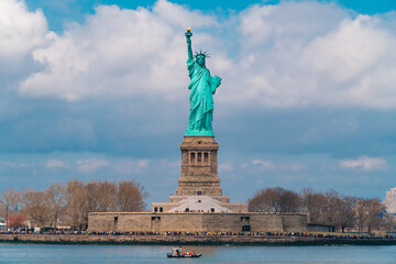 Statue of Liberty on sunny day viewed from Hudson river