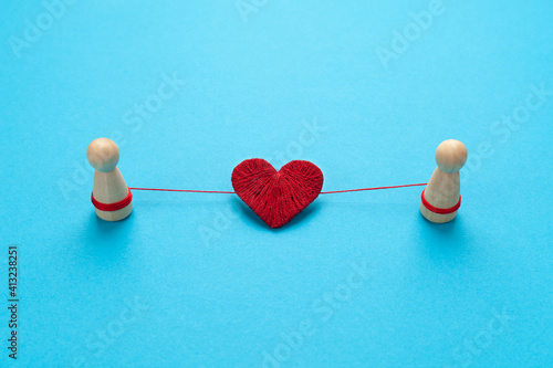 Two figures of people are connected by love. Strong couple.