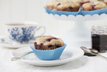 Original Food Photograph Of Fresh Homemade Blueberry Muffins With Blue Liners On A Fresh White Background
