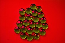 Green Glass Stones On A Red Background