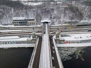 Snow-covered metro bridge in Kiev. Cloudy winter morning. Aerial drone view.