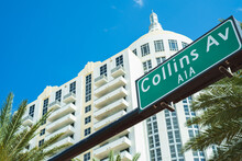 Collins Avenue Street Sign In Miami Beach With Palm Trees And Art Deco Architecture