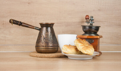 Poster - Two bun with poppy seeds with coffee cup on wood table. Breakfast. Good Morning