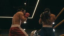 Slow Motion Of Hispanic Boxer Punching Opponent On Boxing Ring