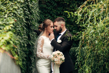 newlyweds near the ivy wall