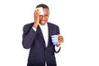 adult businessman wiping forehead with handkerchief while drinki