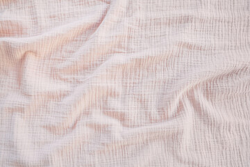 Muslin cloth texture background in neutral tones. Muslin cotton fabric of plain weave. Muslin is a soft, woven, 100-percent cotton multi-layer cloth popular for baby cloths and blankets