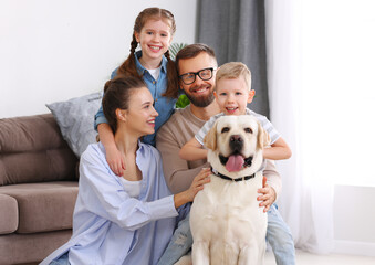 Wall Mural - happy married couple playing with their favorite pet dog   at home