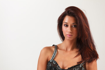 Beautiful young mixed race woman in a fashion pose on a white background