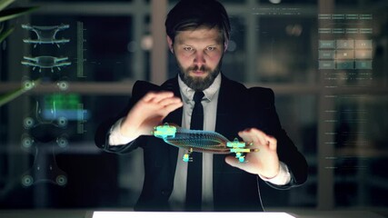 An engineer designs an electric drone using futuristic programs and holographic projection . Concept of: drone, future, project and augmented reality