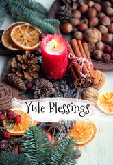 Wall Mural - Yule Blessings. Winter altar for Yule sabbath. pagan holiday. Red candle, wheel of the year, cinnamon, nuts, cones, dry orange slices. Esoteric Ritual for Yuletide, Magical Winter Solstice