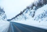 Fototapeta Most - winter road between huge rocks 
