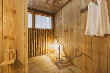 Modern Luxury Summer Holiday Or Vacation Wooden Beach House Restroom Interior With Rustic Wooden Walls, Sink And Organic Straw Chandelier.
