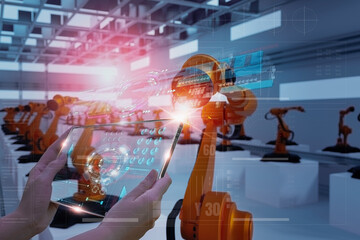 Wall Mural - industry engineer in factory,using smart tablet glass device,control automated robot arm machine lea