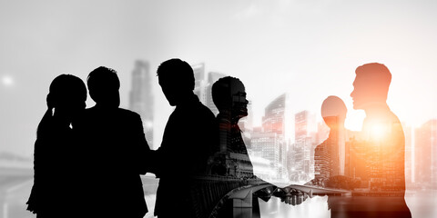 Wall Mural - silhouette view of business people team in group meeting on city office building background showing 