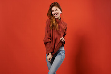 fashionable woman in red sweater and jeans casual wear posing isolated background