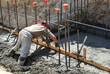 © Mel Stoutsenberger - Mason troweling fresh concrete footing