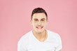 © SHOTPRIME STUDIO - Cheerful handsome man in white t-shirt emotions pink isolated background