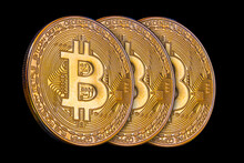 A Trio Of The Golden Bitcoin Coins On A Black Background.